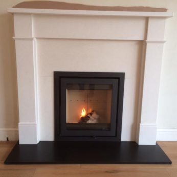 Dik Geurts Instyle Insert stove with Hersham Agean Limestone surround Dean Forge